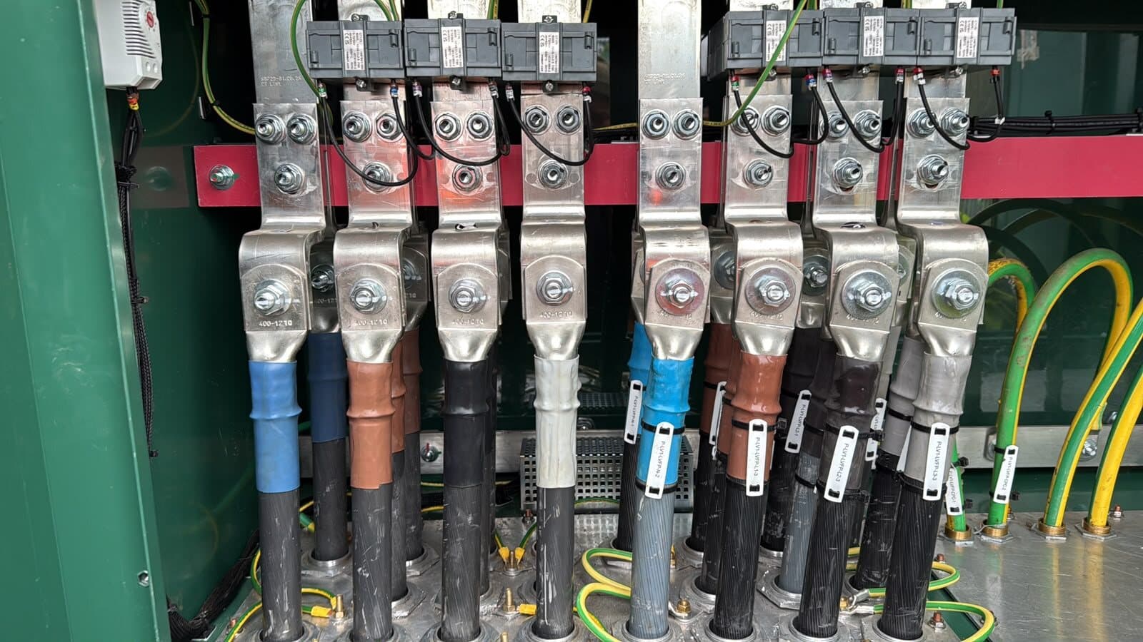 Close-up of terminated cores on the busbars, each one numbered and torque marked