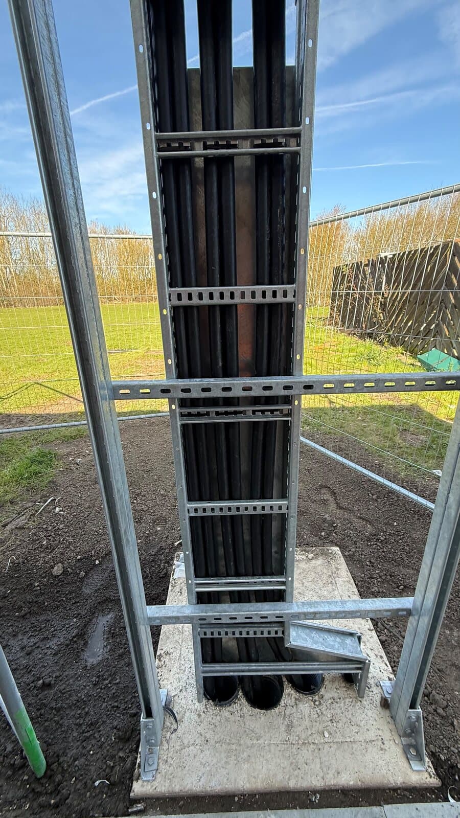 Basket and tray taken up a riser frame with the cables dressed in behind
