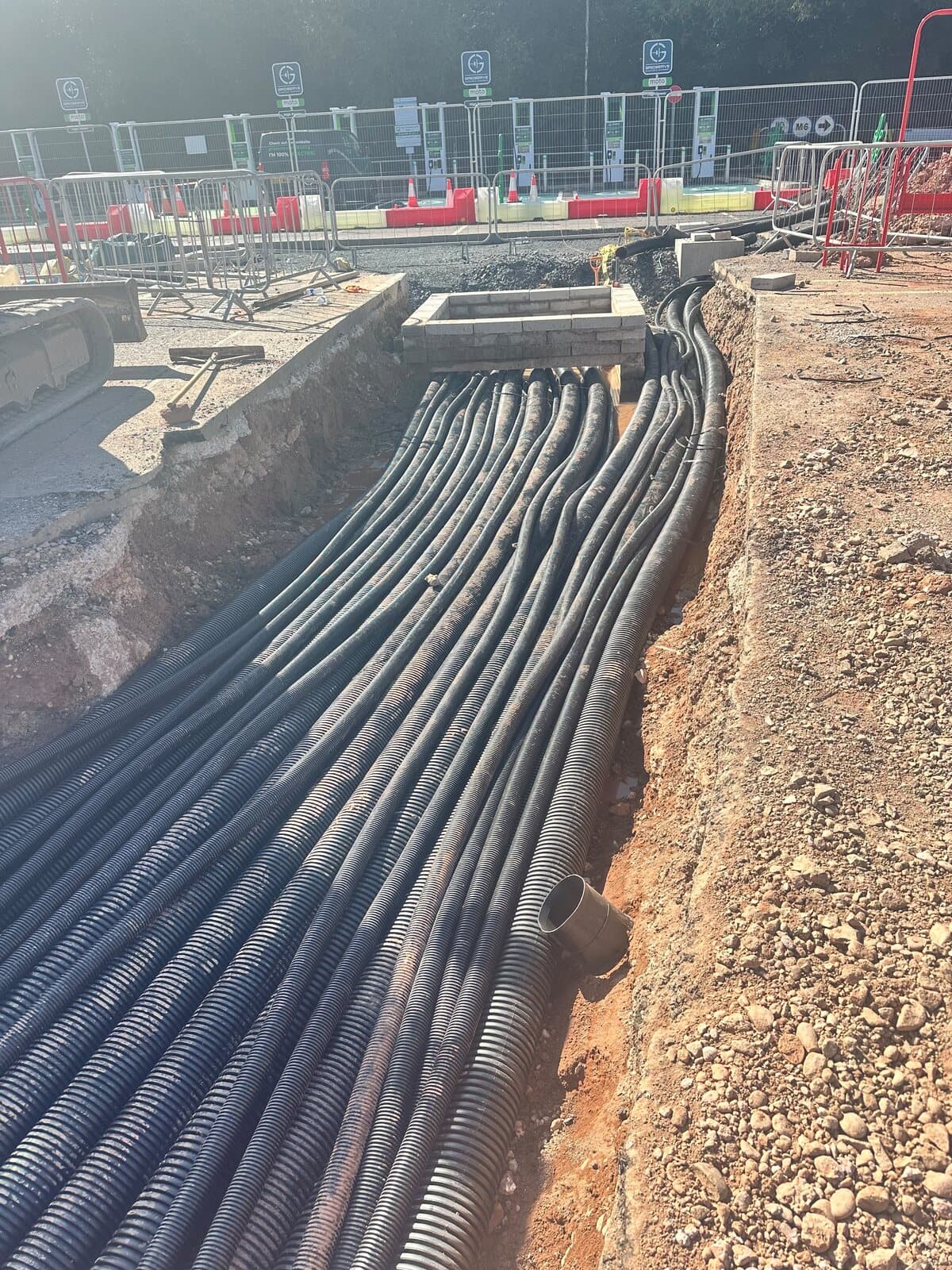 Long straight run of ducting laid the length of an open trench