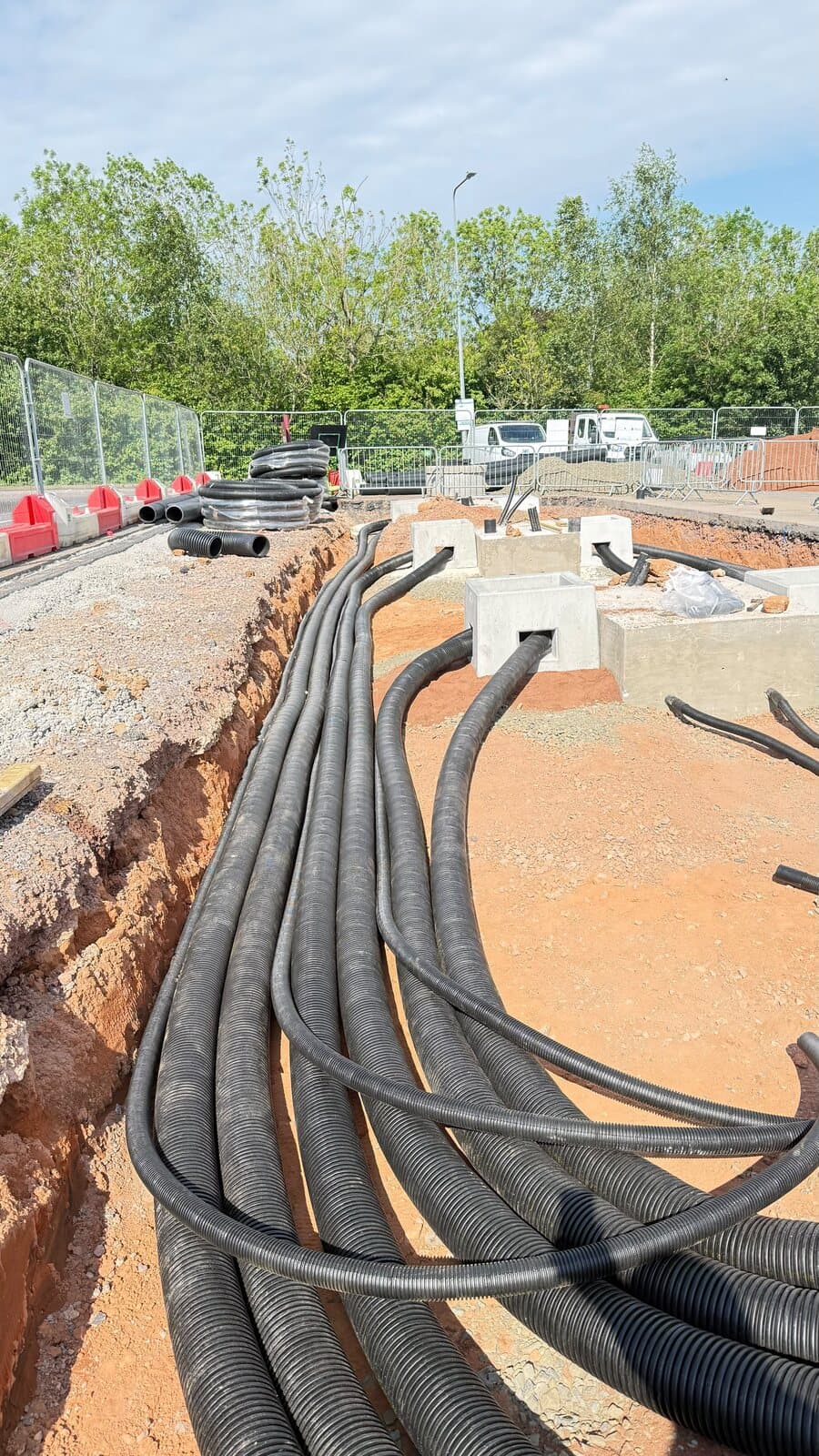 Ducting swept round into the trench on a long run across site