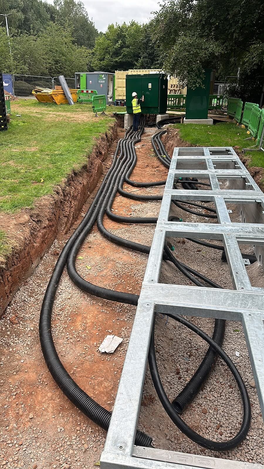 Cable ladder set out alongside an open trench with the cables laid in and swept to the pillar position