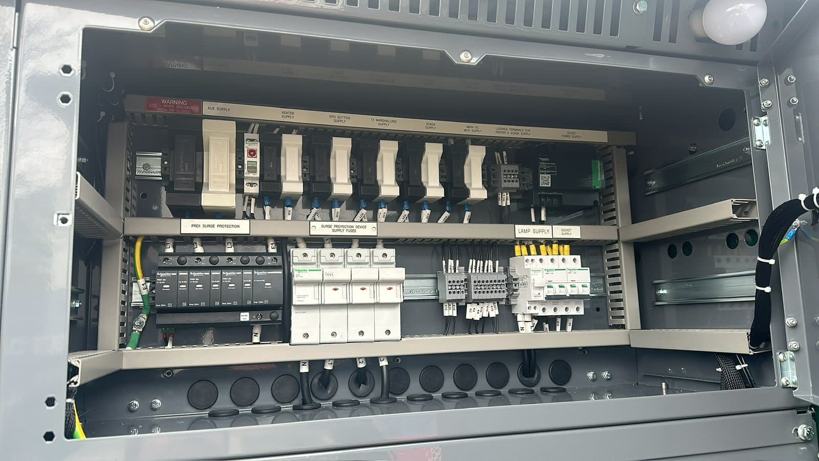 Control panel fitted with surge protection, circuit breakers and contactors, wired and identified