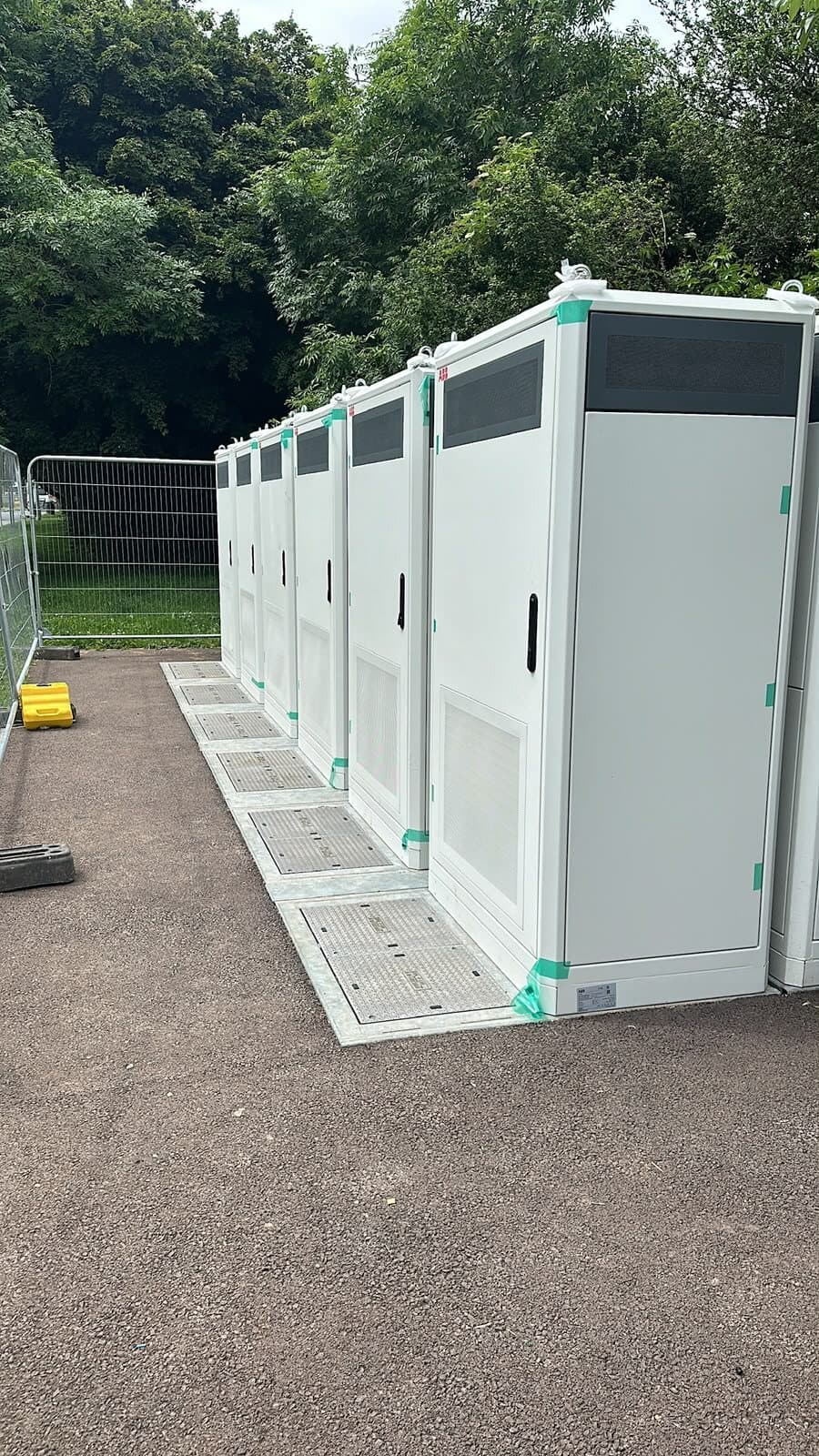 Row of charging units set on new plinths and connected, ready for commissioning