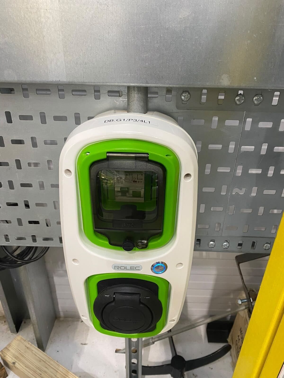 Wall-mounted car charger fitted to new containment, with the supply run in and the circuit labelled