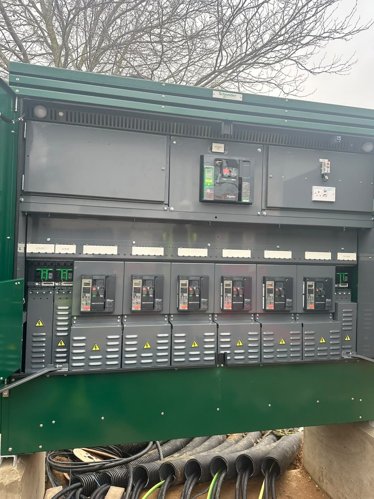 Feeder pillar opened up, showing a row of moulded case circuit breakers above the outgoing ways