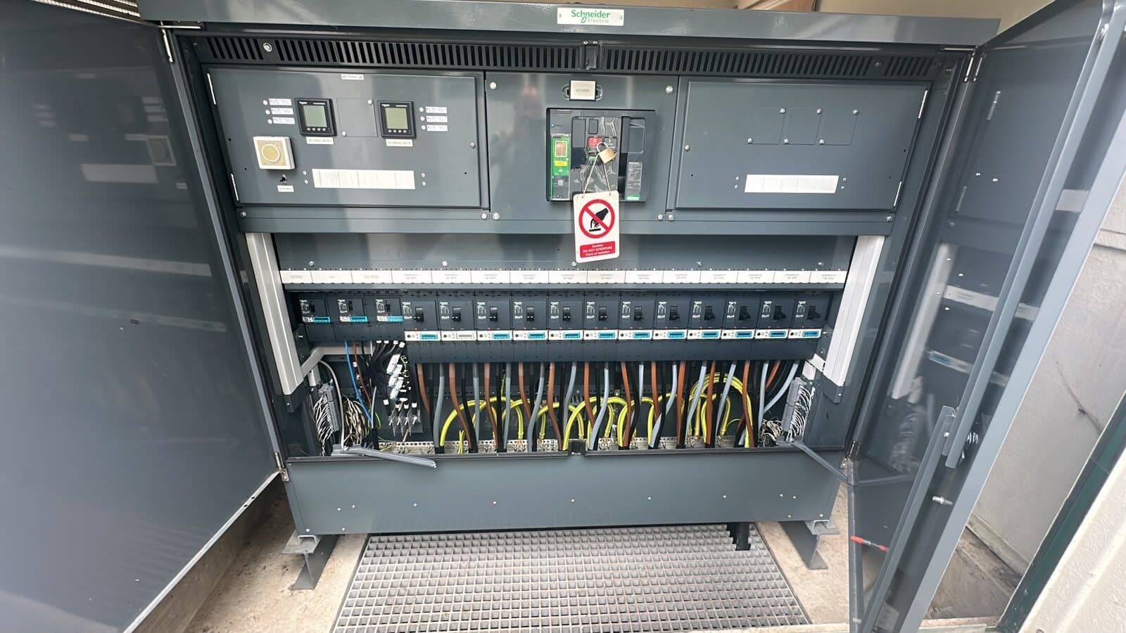 Switch panel opened for testing, with the control wiring and terminals set out neatly