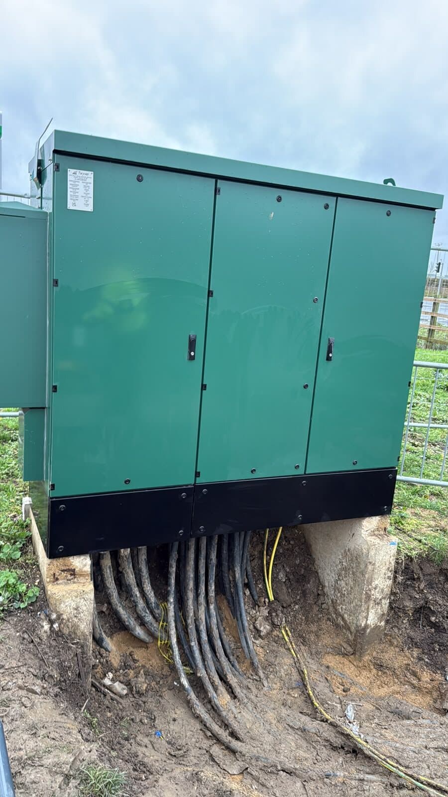 Feeder pillar with the outgoing cables brought up out of the trench and into the base