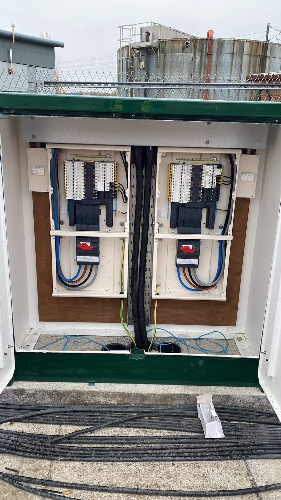 Distribution pillar opened up on an industrial site, both boards wired and live