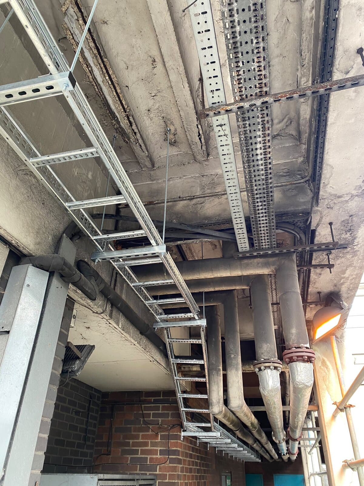 Cable ladder and tray set out across a plant room ceiling, ready for the cables