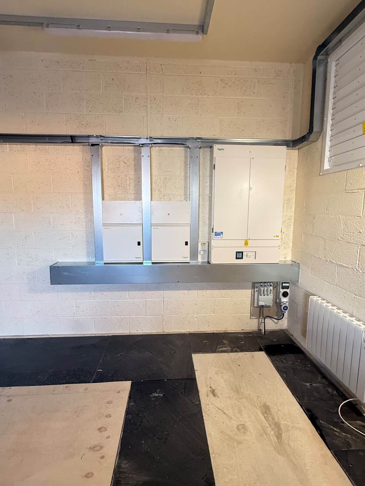 New boards mounted on a galvanised support frame in a plant room, first fix complete