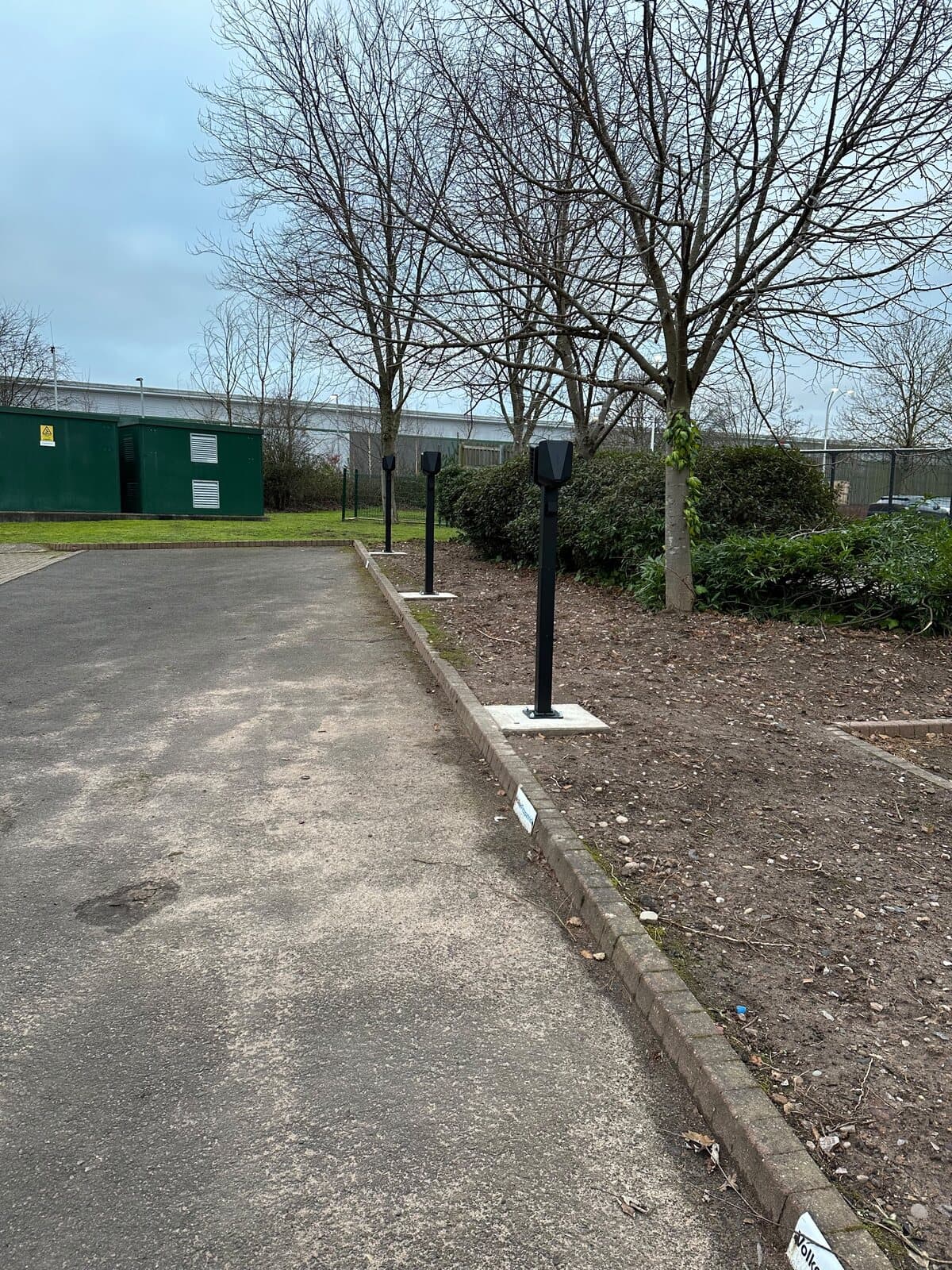 Substation and charge points finished in a landscaped business park car park