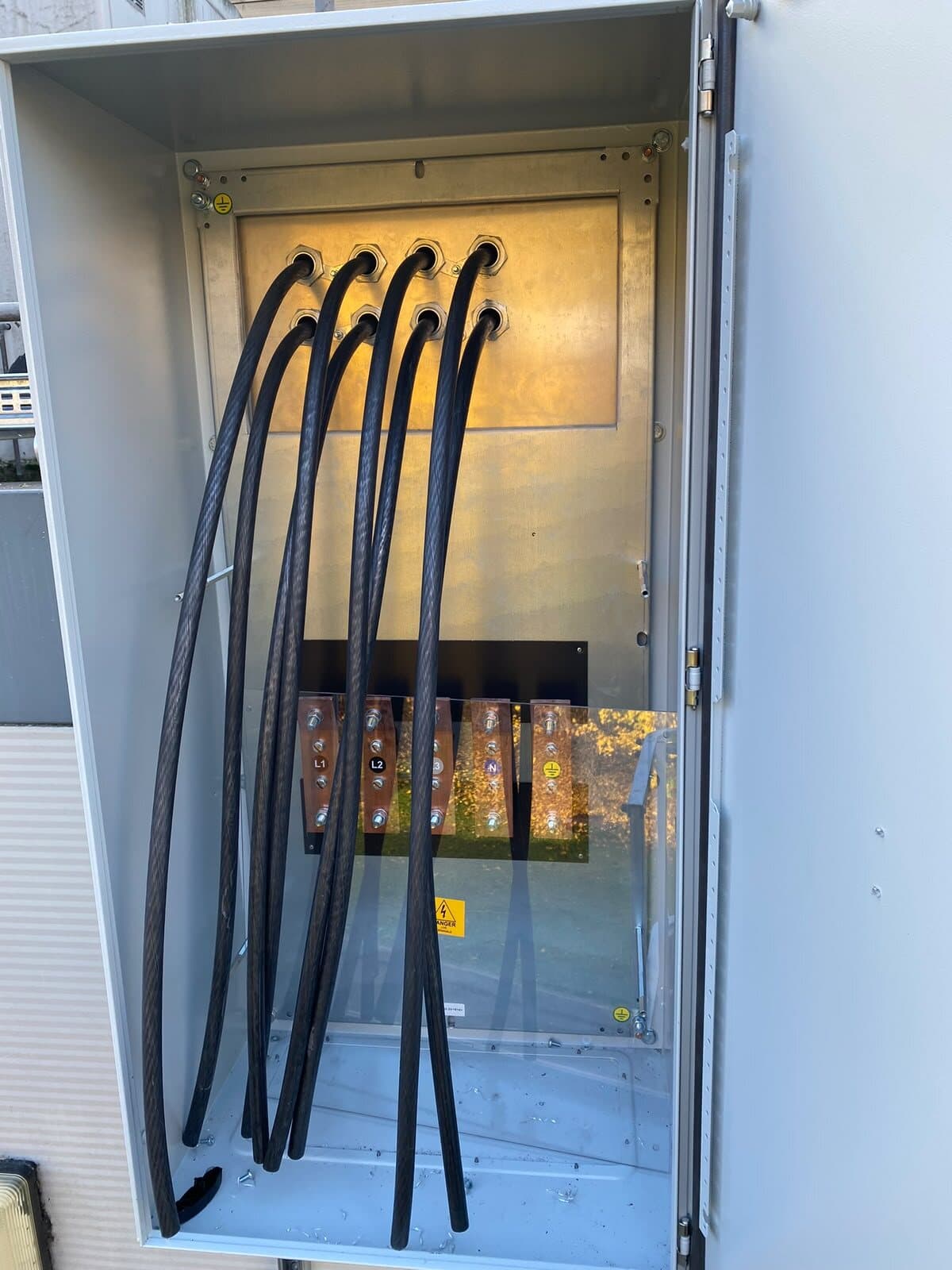 Armoured cables swept up into the busbar chamber of an outdoor enclosure